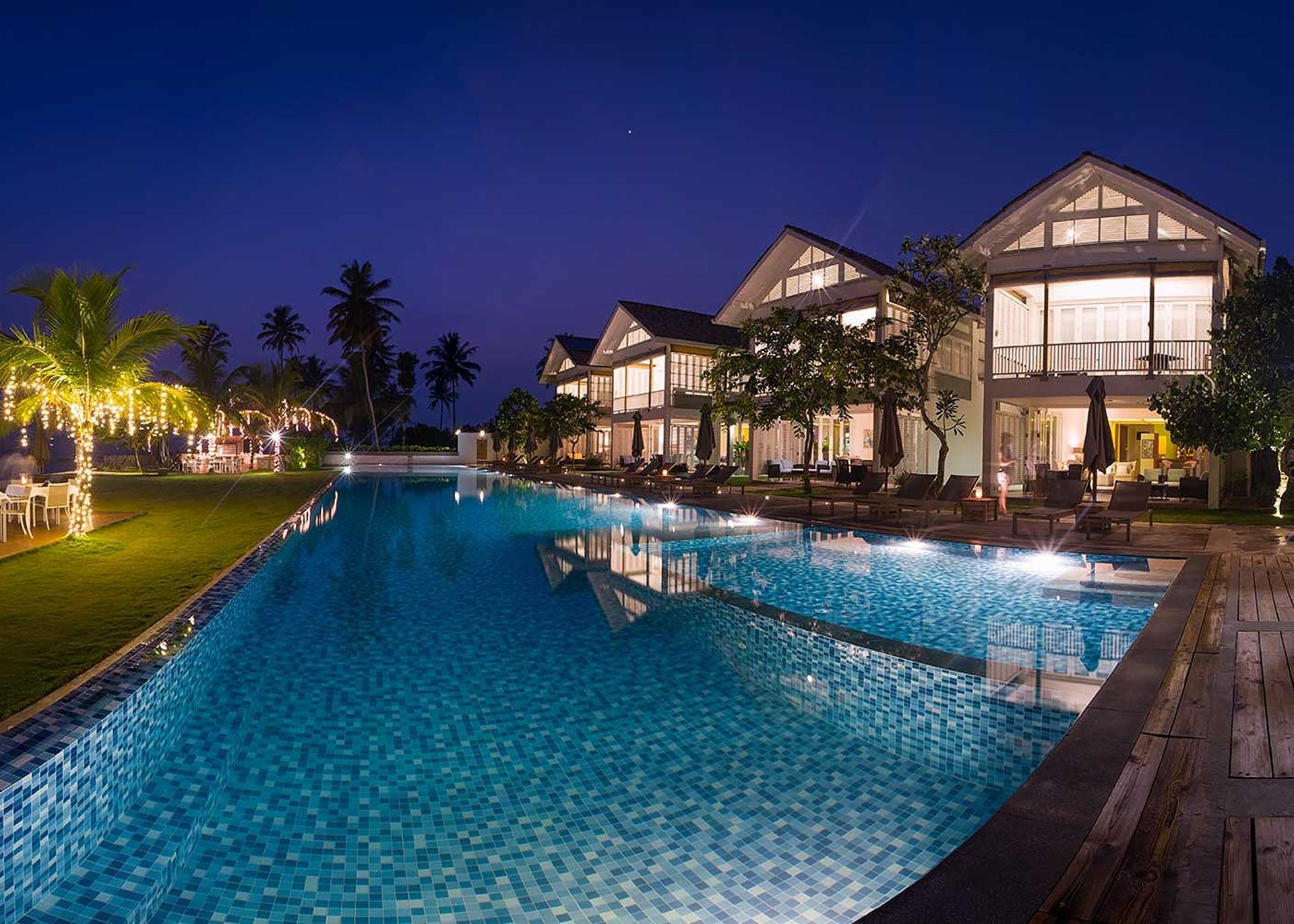Villas at night with lit pool, Sri Sharavi Mirissa