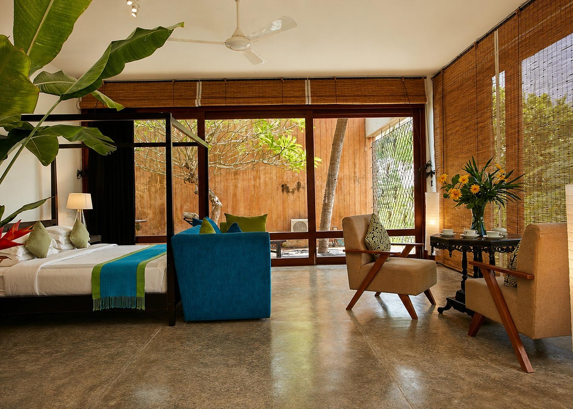 Mirissa bedroom with teal sofa and plant