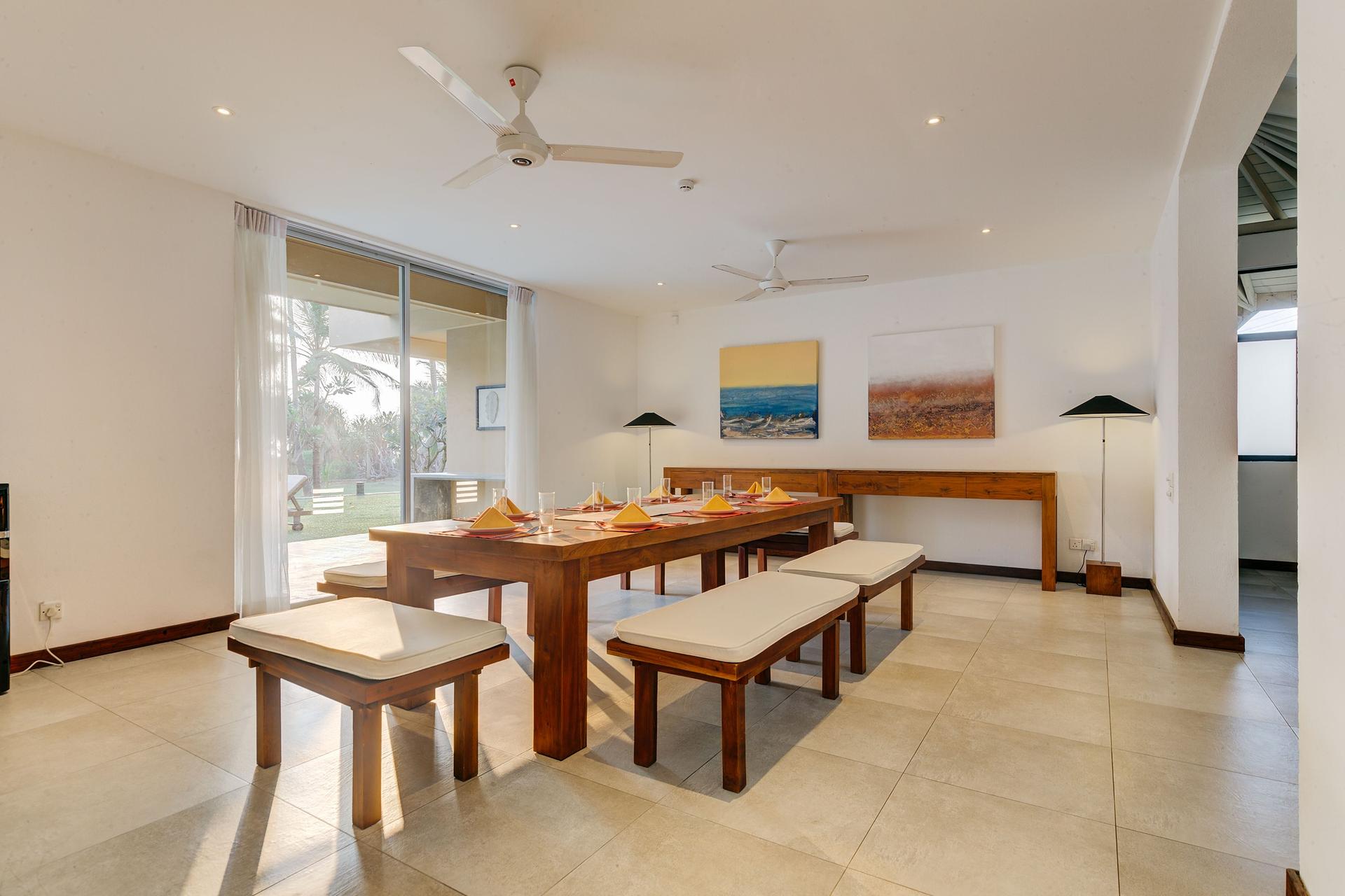 Open-air dining pavilion at a beachfront villa in Wadduwa with garden setting
