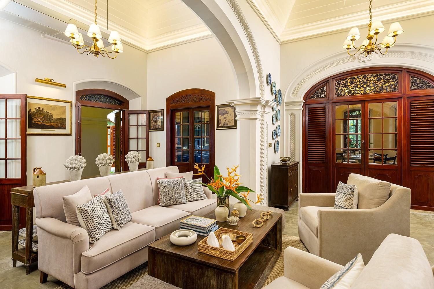 Elliot House Galle sitting room with cream sofas and colonial arched openings