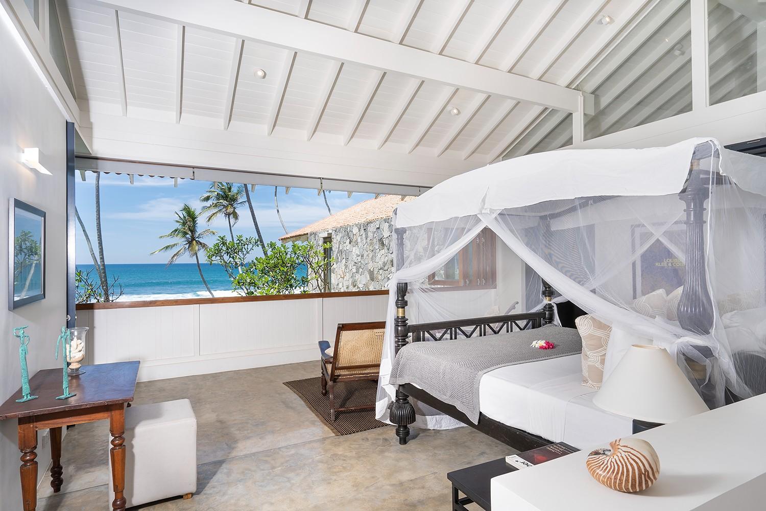 Talpe beachfront villa four-poster bedroom with balcony and Indian Ocean view