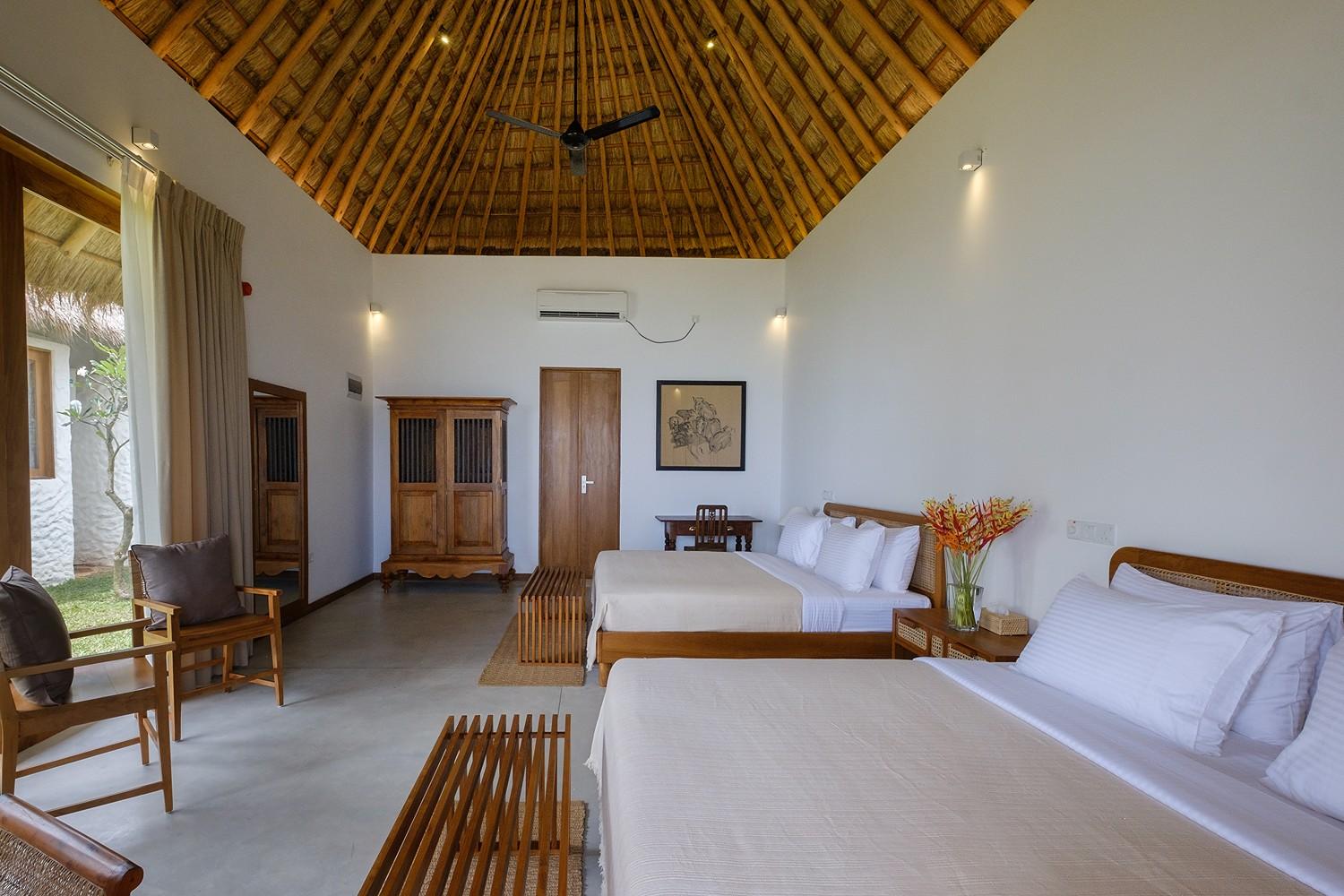 Mirissa villa family room wide angle with thatched ceiling and timber