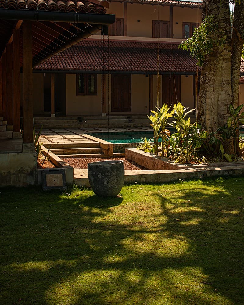 Villa garden with pool and lounge area surrounded by tropical plants
