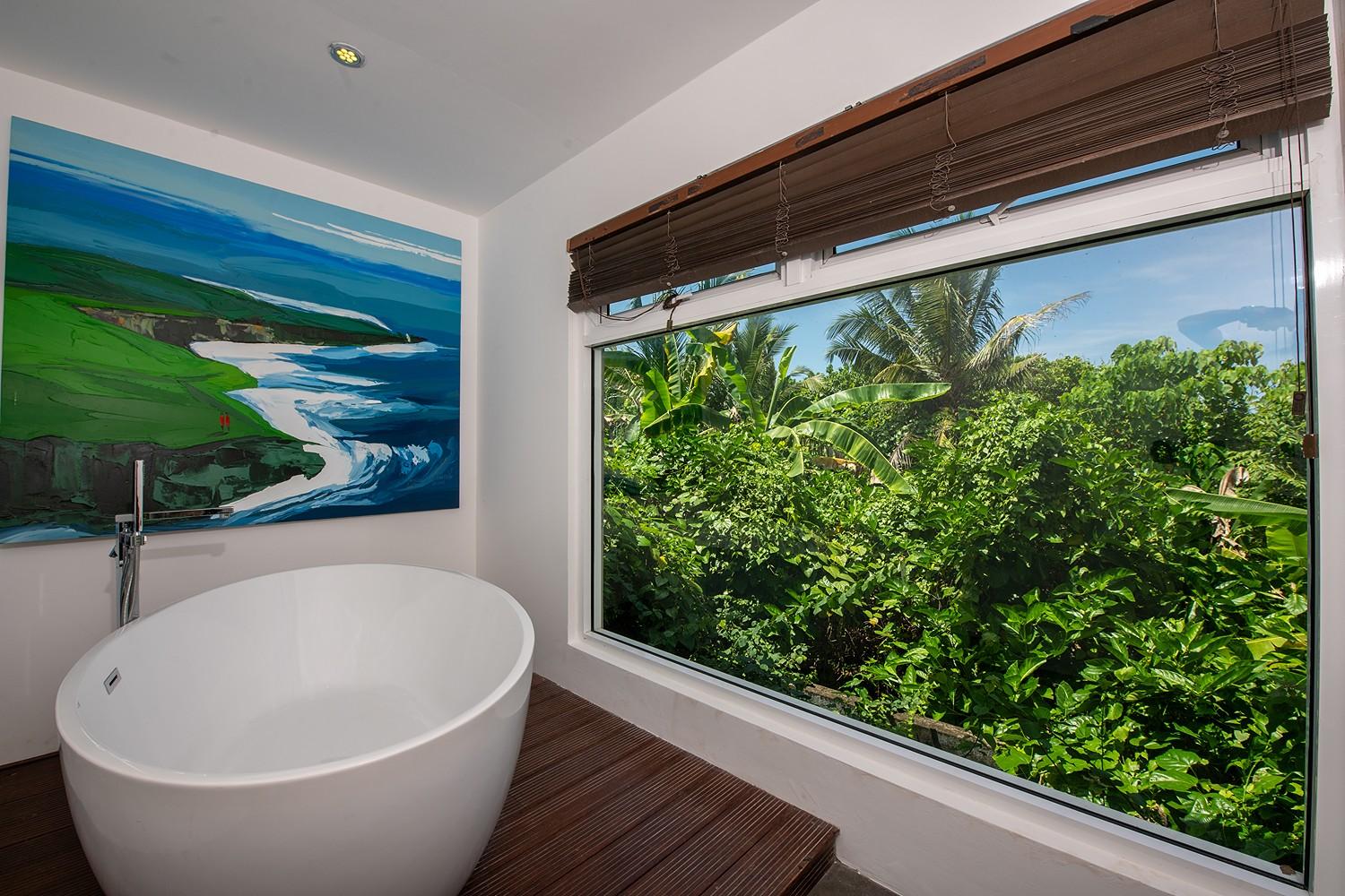 Casa Tua master bathroom with freestanding bathtub and garden view