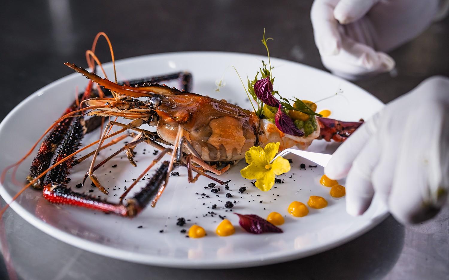Fine dining plated lobster with edible flowers