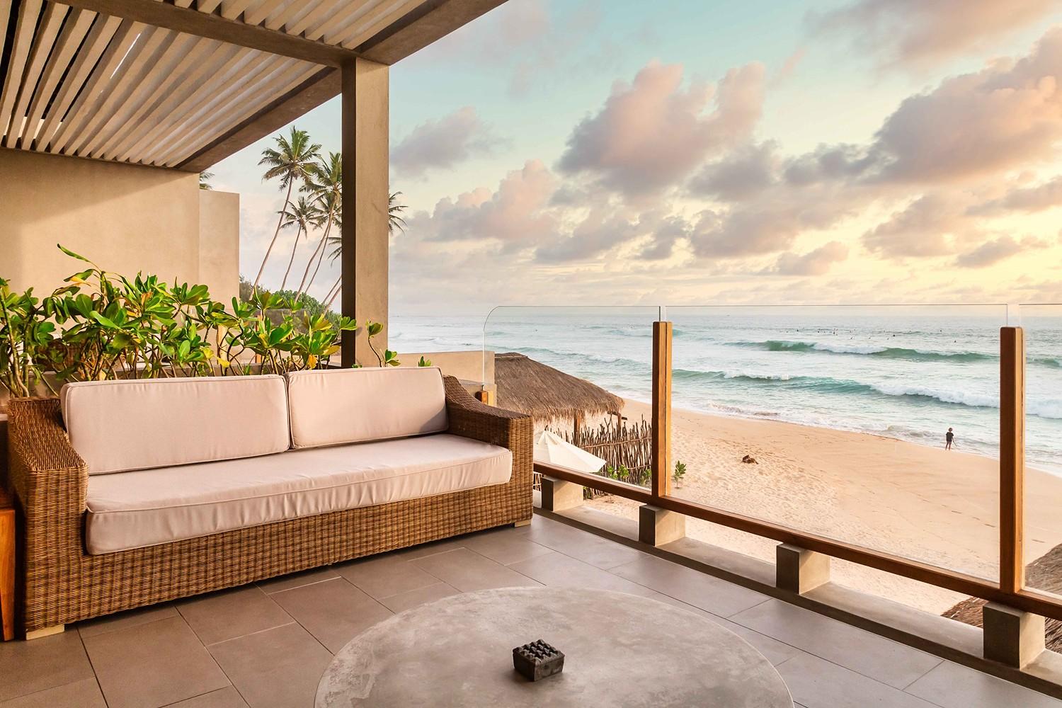 Terrace sofa with beach view under cloud sky at The Six Weligama, Midigama, Sri Lanka