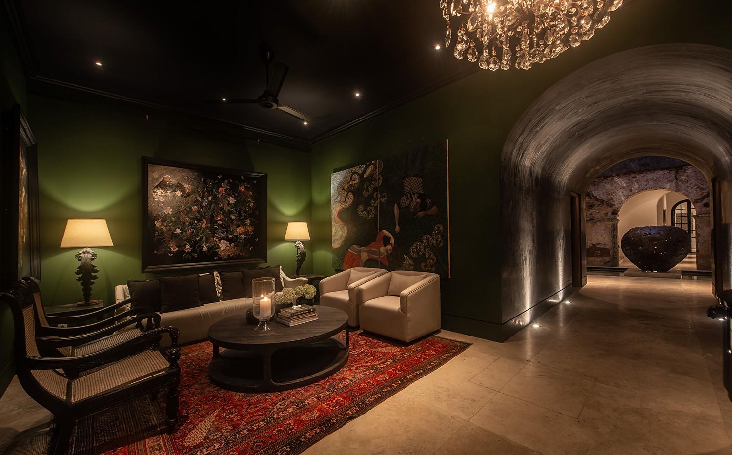Green lounge with lit painting and chandelier, No. 77 Leyn Baan, Galle Fort, Sri Lanka