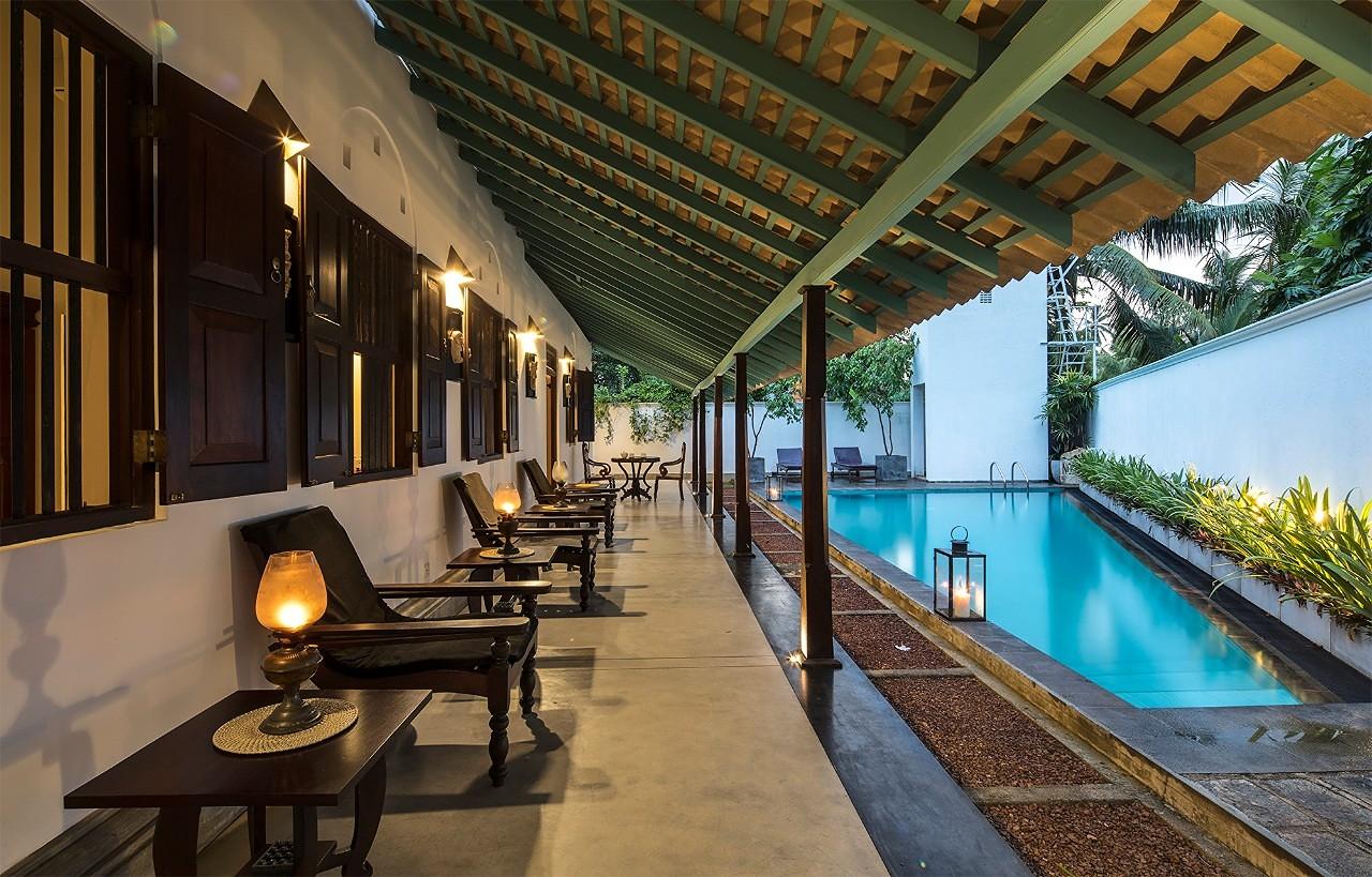 Pool colonnade from opposite angle at evening, Magalla Casa