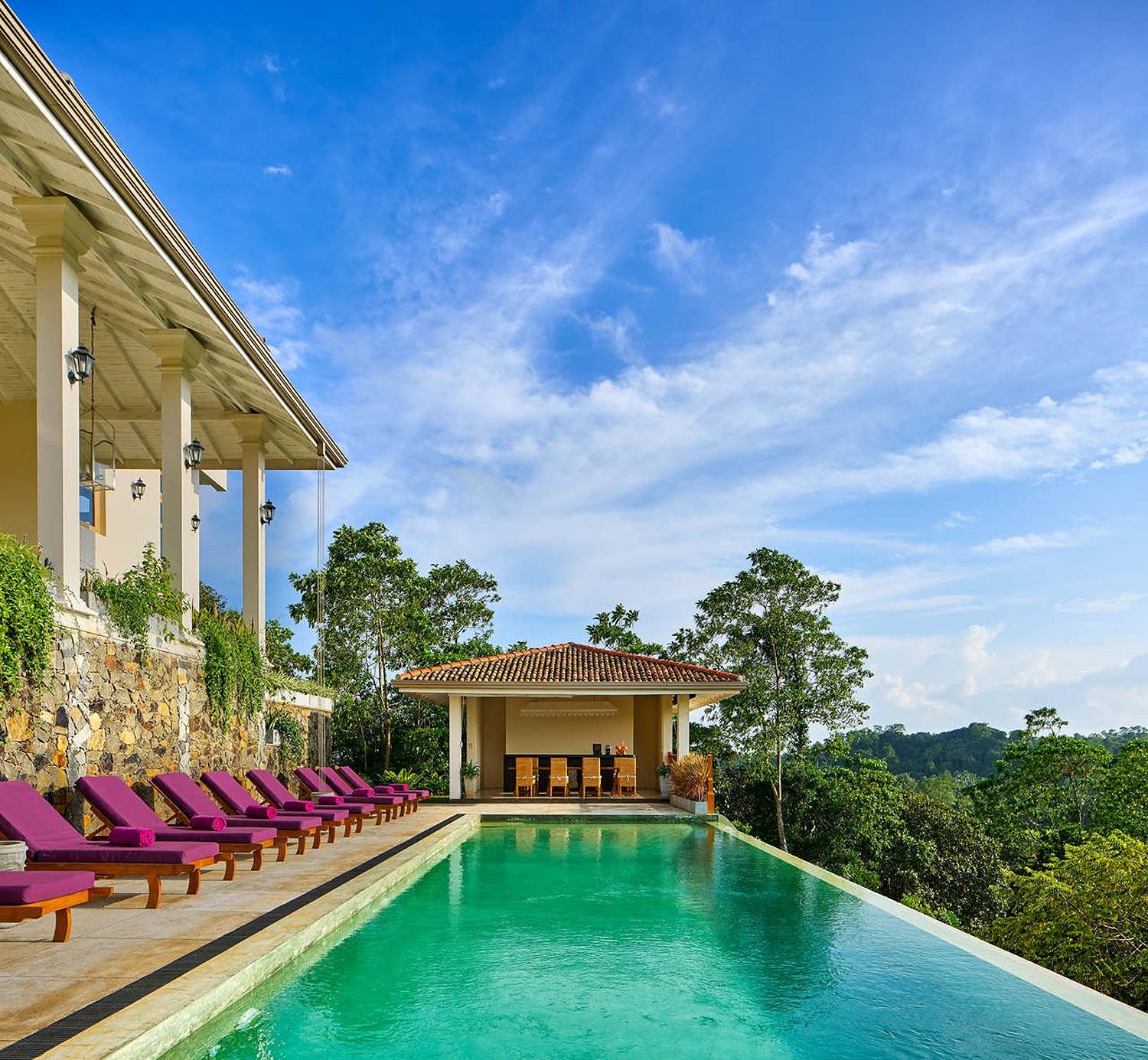 Pool deck wide with hills behind, The Divine Villa Talpe