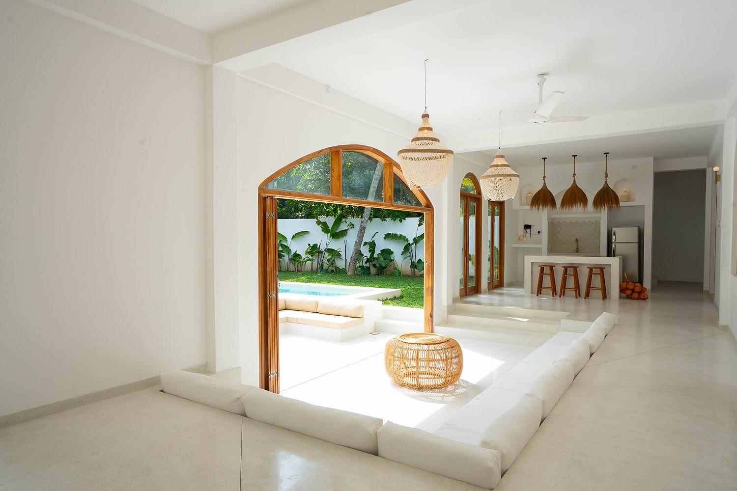 Ahangama living room with sofa and round mirror